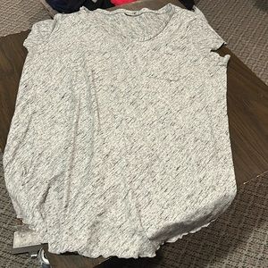 T shirt with ruffles at bottom and a front pocket size L